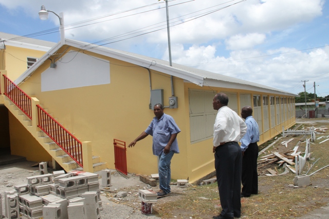 Premier of Nevis and Minister of Education Hon. Vance Amory (center) accompanied by Permanent Secretary in the Premier’s Ministry Wakely Daniel (right) touring the Charlestown Secondary School on August 11, 2015 with contractor Jonathan Liburd (left) for a first-hand look of progress on the Schools Rehabilitation Project there